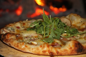 Figlio Pear and Brie Pizza garnished with arugula 